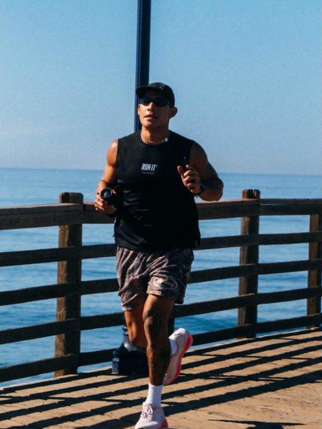 Marc Reina running on a pier