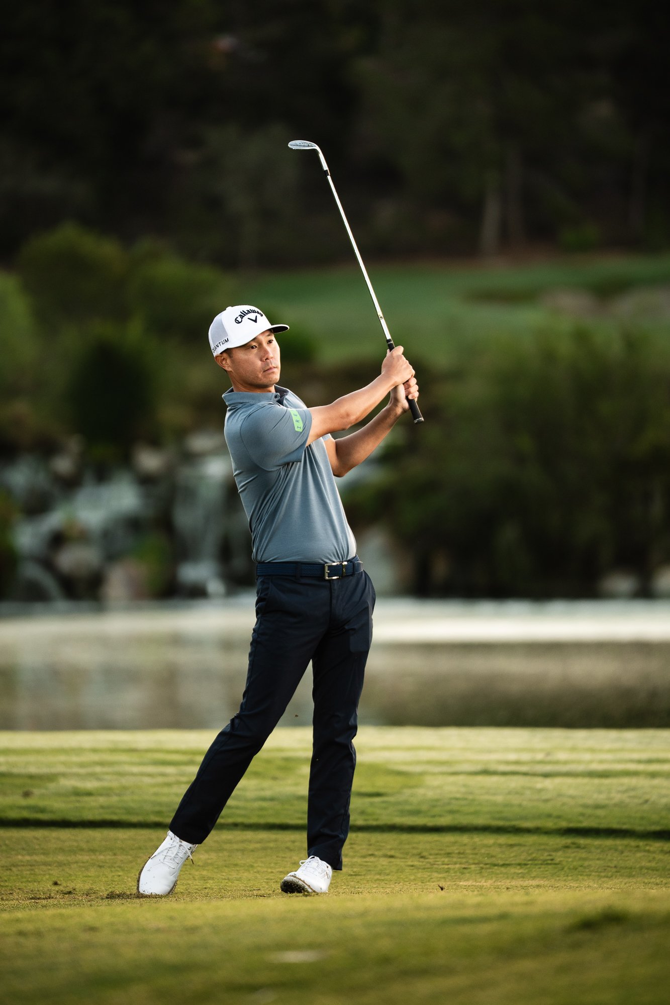 Golfer holding his finish on the fairway